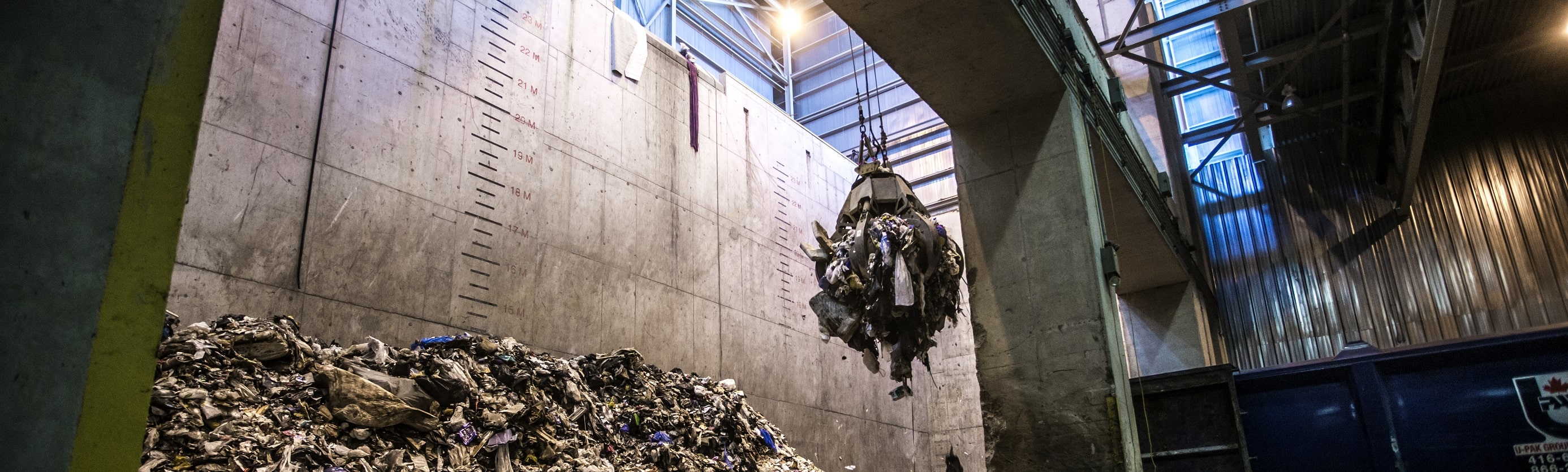 A large grapple holding a pile of garbage
